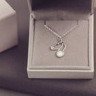 Silver necklace with a pendant in an open jewelry box