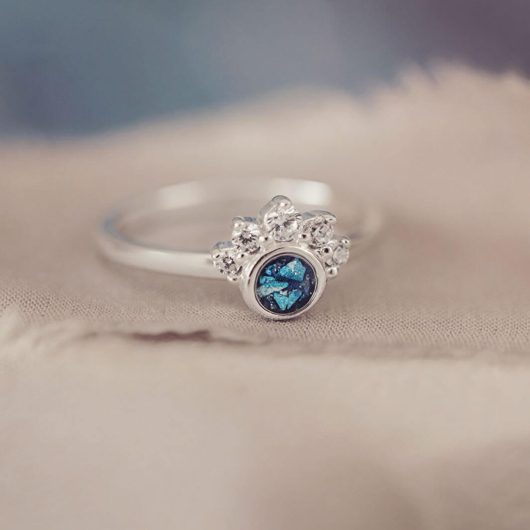 Sterling Silver Ornate Ring with blue gemstone, on a pale background
