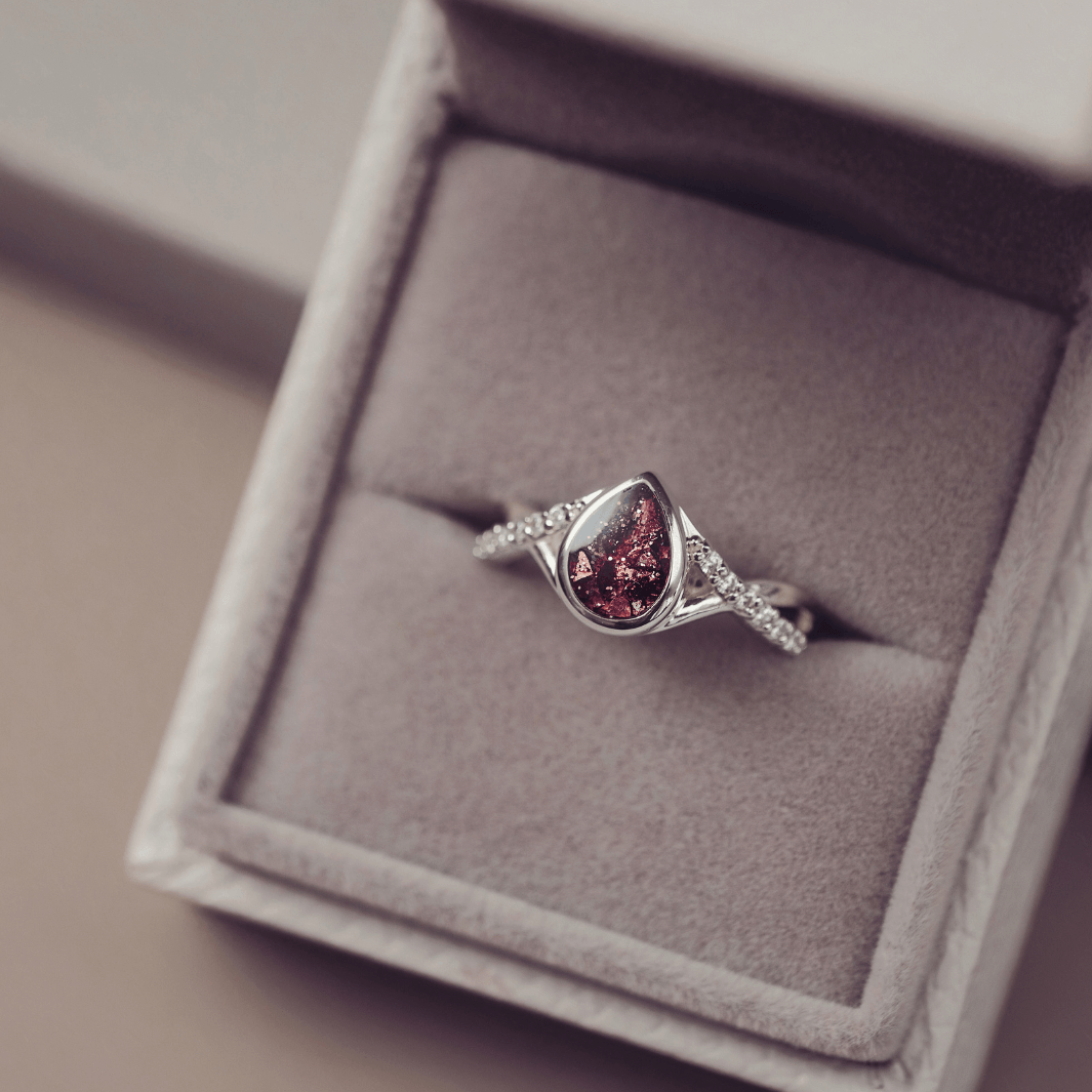 Sterling Silver Peardrop Ring with Crystals on the Band, holding cremation ashes and brown crystal
