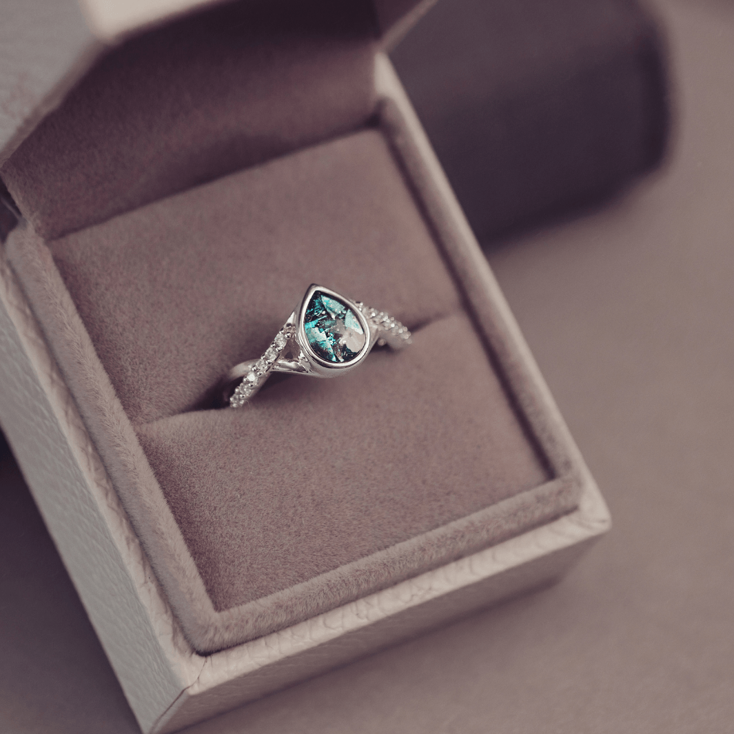 Sterling Silver Peardrop Ring with Crystals on the Band, holding cremation ashes and turquoise crystal