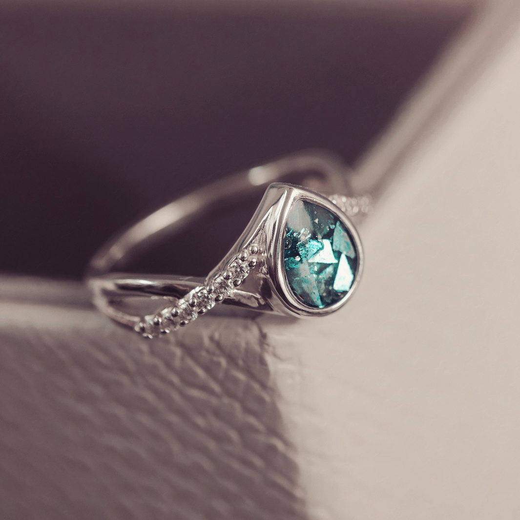 Sterling Silver Peardrop Ring with Crystals on the Band, holding cremation ashes and turquoise crystal