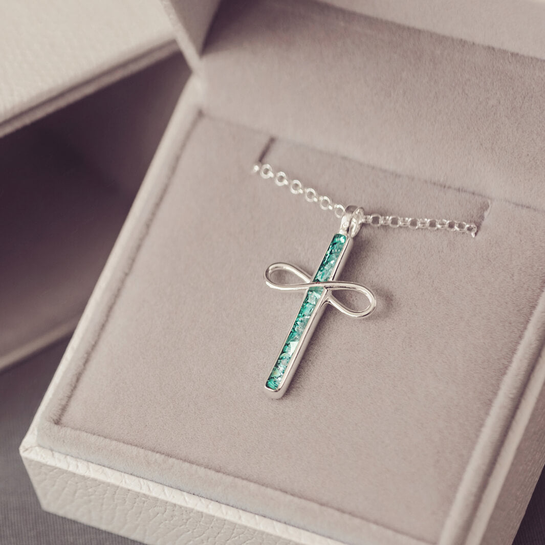 Sterling Silver Cremation Ashes Cross Necklace, filled with cremation ashes, green crystal and resin. On a silver ball chain sat in a grey jewellery box 