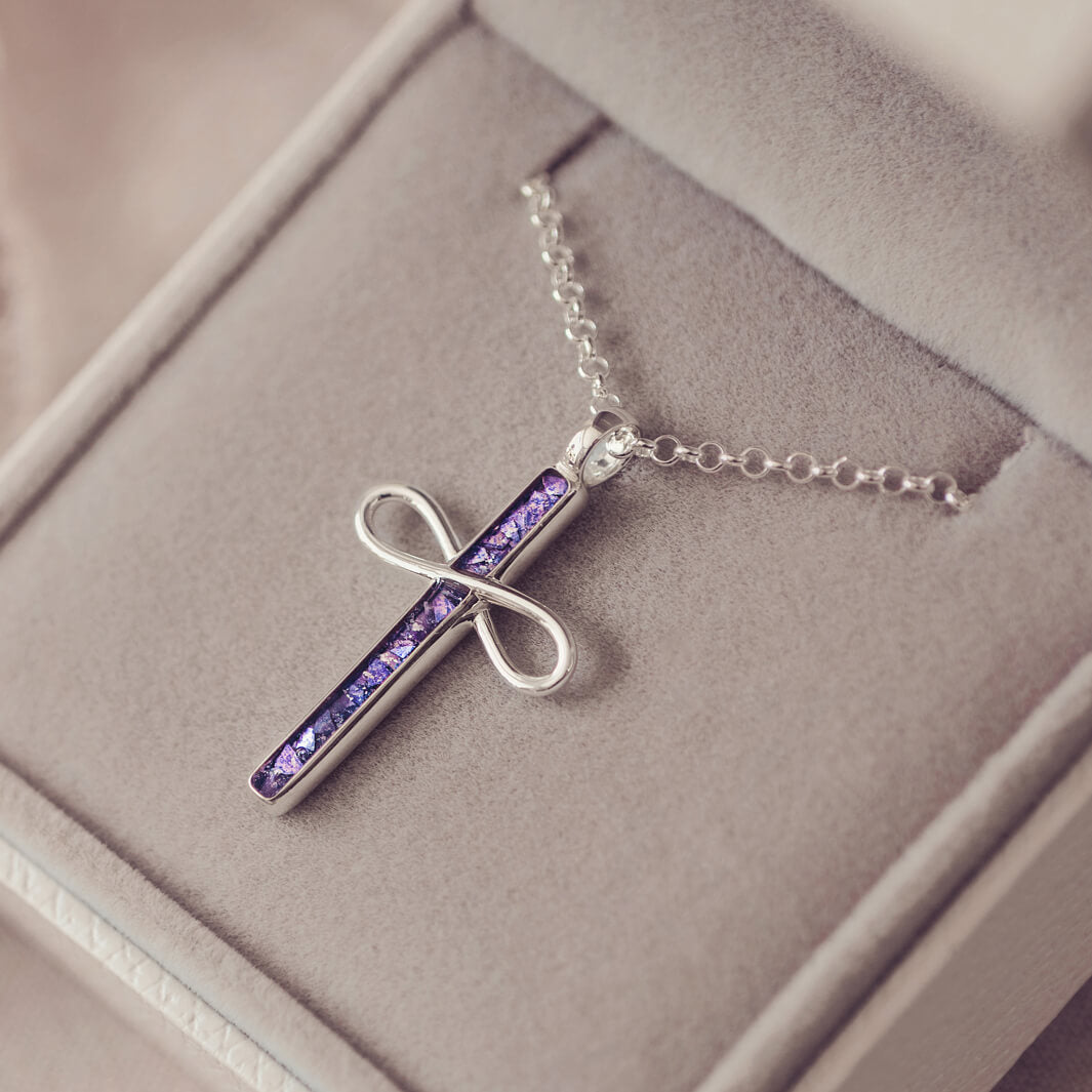 Sterling Silver Cremation Ashes Cross Necklace, filled with cremation ashes, purple crystal and resin. On a silver ball chain sat in a grey jewellery box 